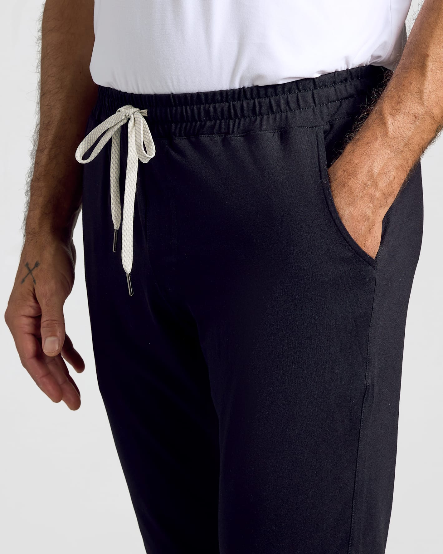 Wearing All Black Active Joggers 3-Pack with elastic waistband and drawcords.