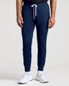 Dark Heather Navy joggers with drawstring, cuffed ankles, and white sneakers.