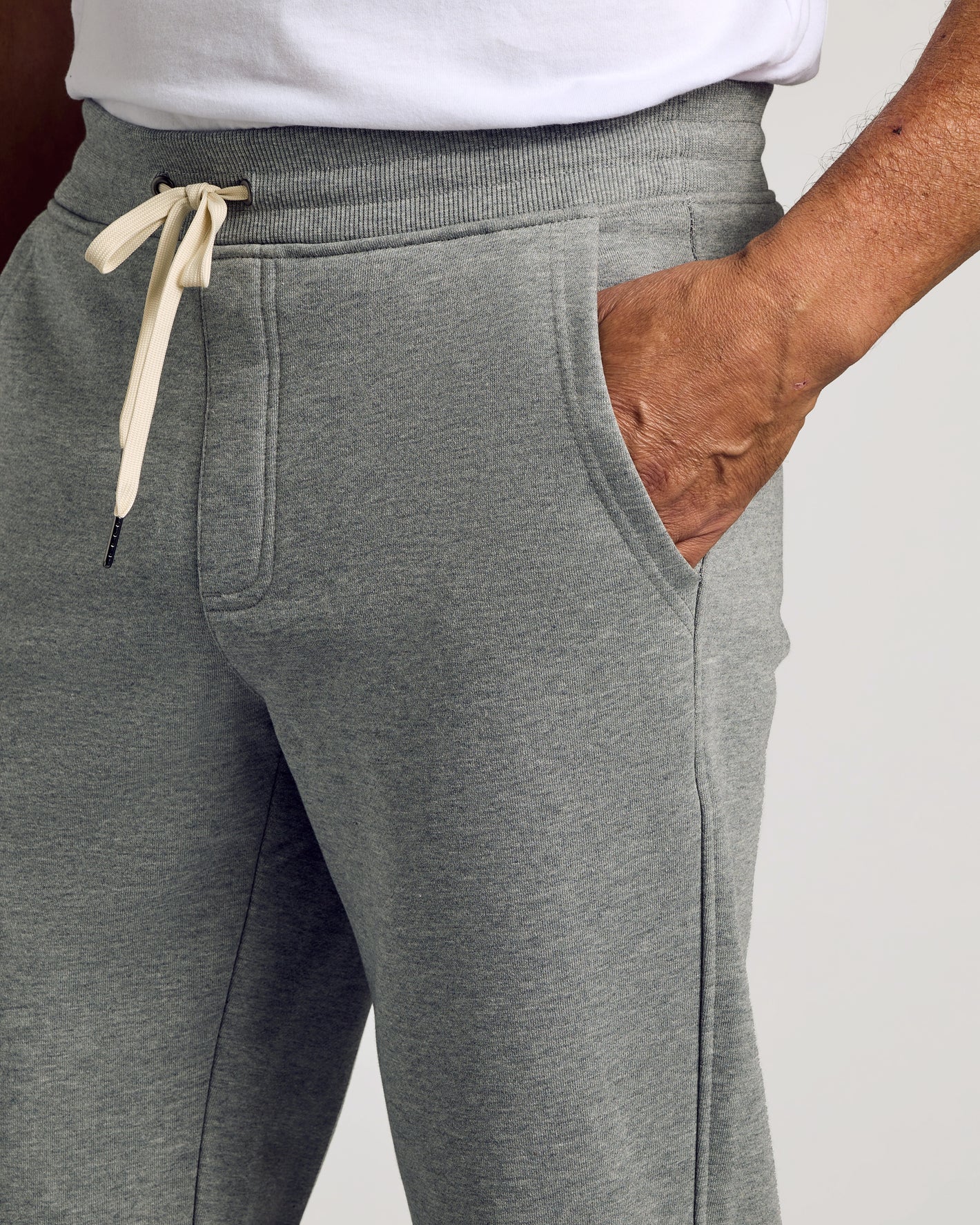 Person wearing Dark Heather Gray Fleece French Terry Joggers with drawstring.