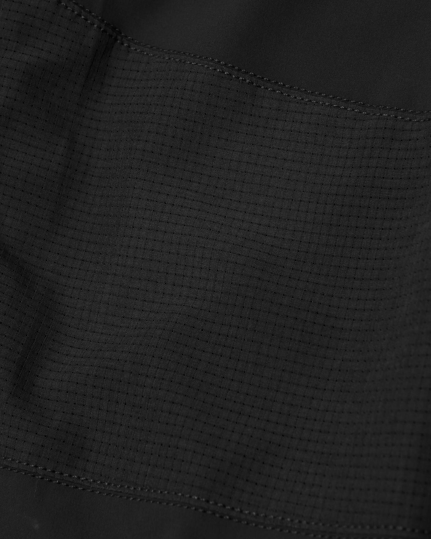 Black Active Training Joggers' rip-stop fabric panel with reinforced stitching.