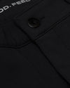 Black Commuter Pants detail: matte snap button on pocket flap, “OD.FEEL” text.