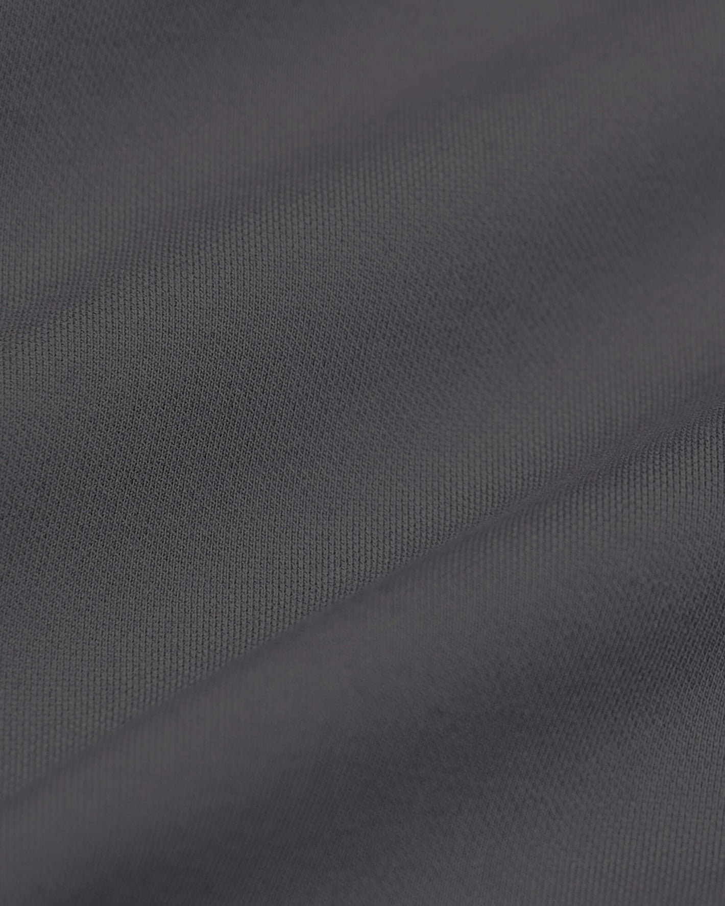 Carbon Commuter Pants close-up, showcasing dark gray woven texture.