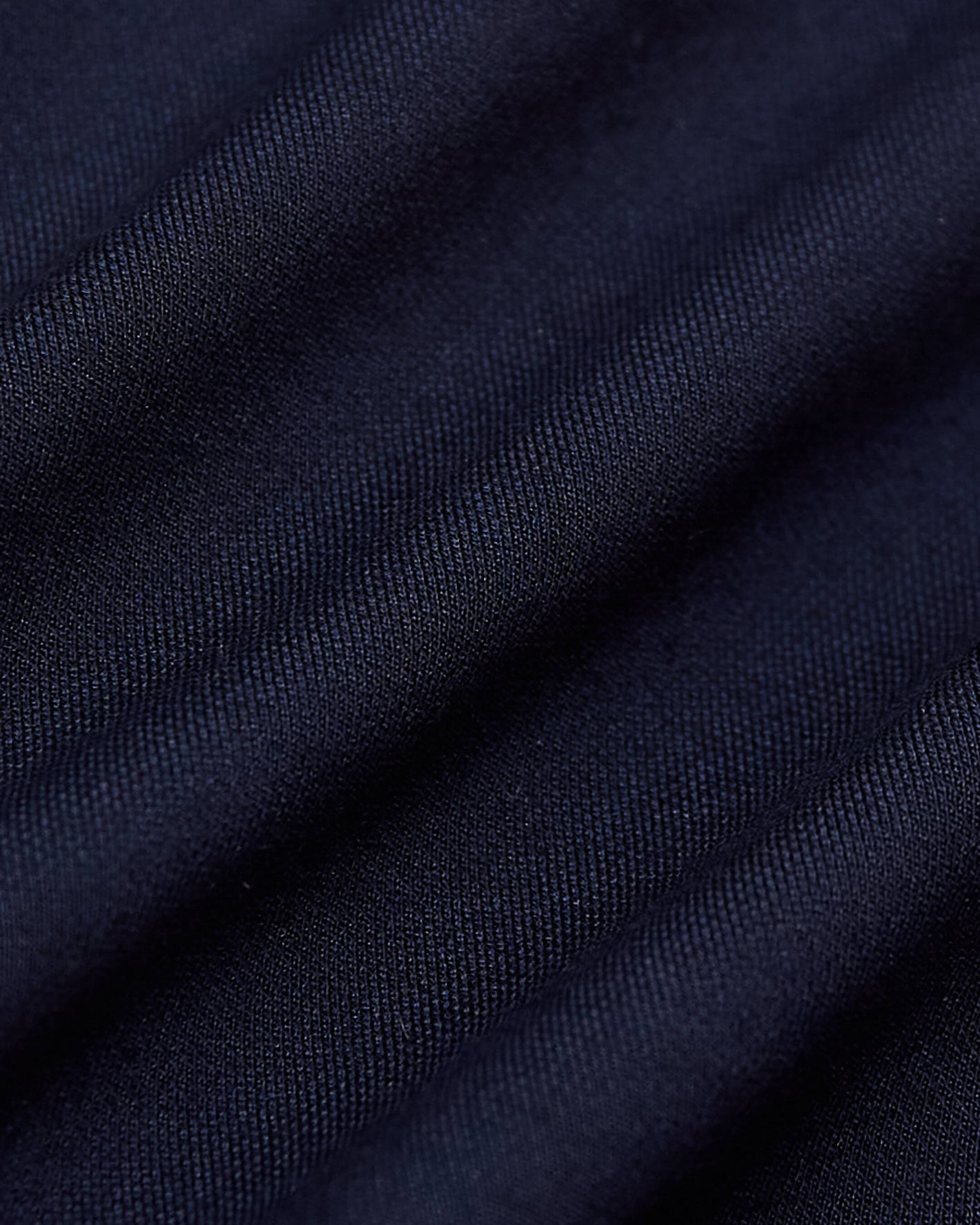 Navy Commuter Pants fabric with fine diagonal weave and soft folds.