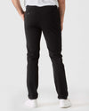 Black Slim Twill Chino Pant with stretch, buttoned back pockets, white sneakers.