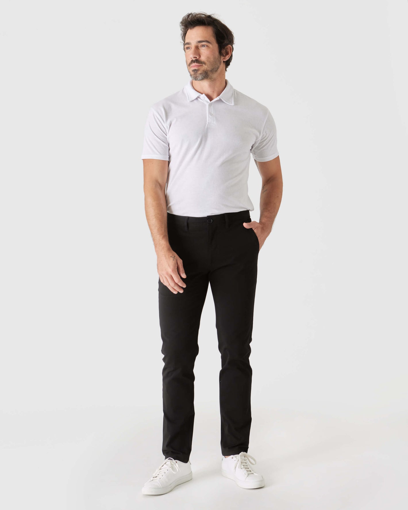 Male model wearing Black Slim Twill Chino Pant, white polo.