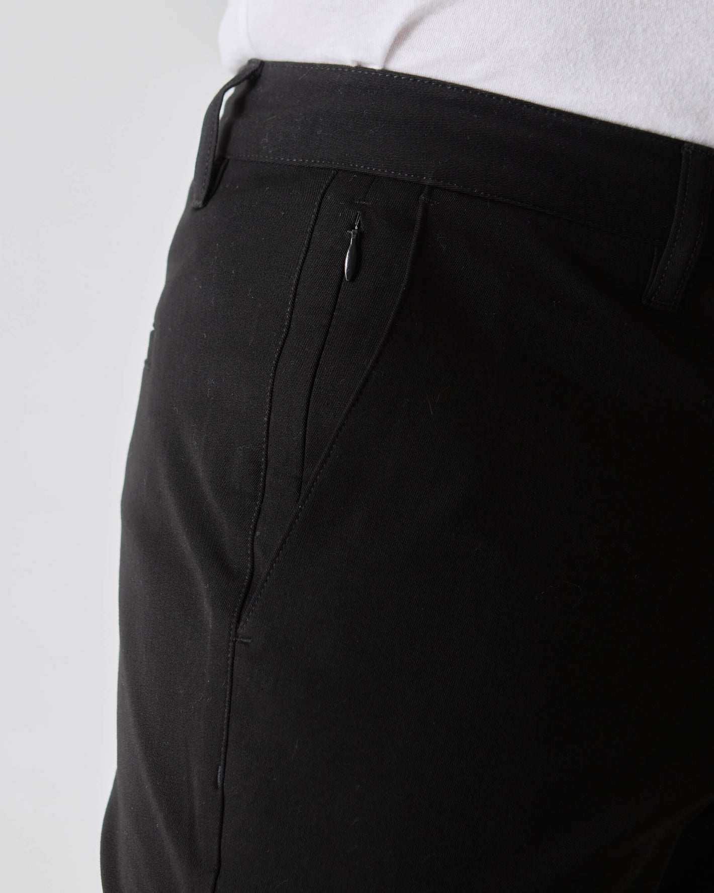 Black Slim Twill Chino Pant with belt loops and zippered side pocket.