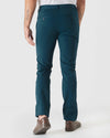 Man wearing Centurion Slim Twill Chino Pant, teal-blue, with brown sneakers.