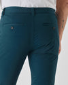 Centurion Slim Twill Chino Pant, dark teal, welt pockets, arrow tattoo visible.