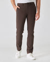 Dark Oak Slim Twill Chino Pant with white sneakers, studio setting.