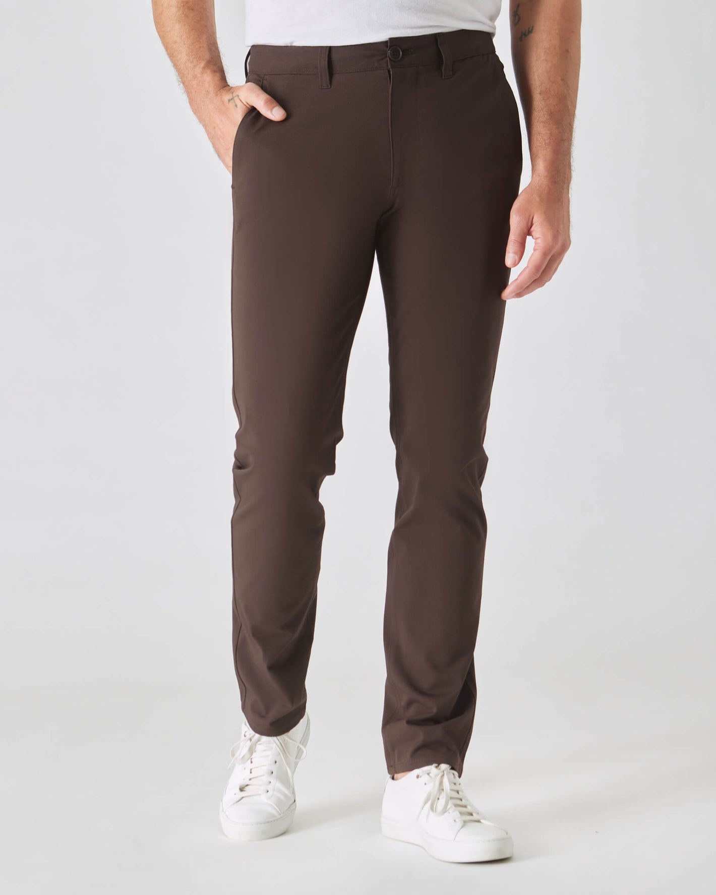 Dark Oak Slim Twill Chino Pant with white sneakers, studio setting.