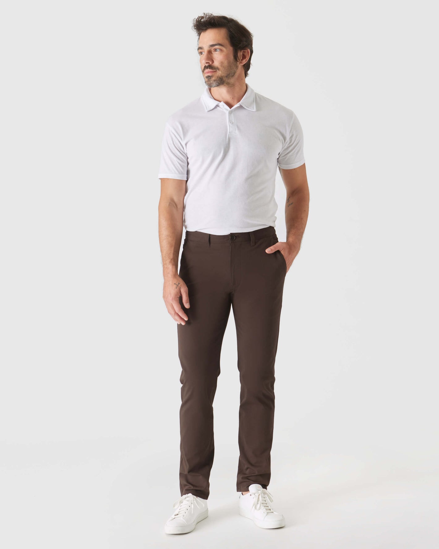 Model wearing Dark Oak Slim Twill Chino Pant with white polo.