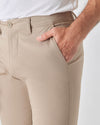 Khaki Slim Twill Chino Pant with white top, hand in pocket.