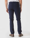 Navy Slim Twill Chino Pant shown from the back with sneakers.
