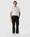 Man wearing Black Straight Twill Chino Pant with white polo.
