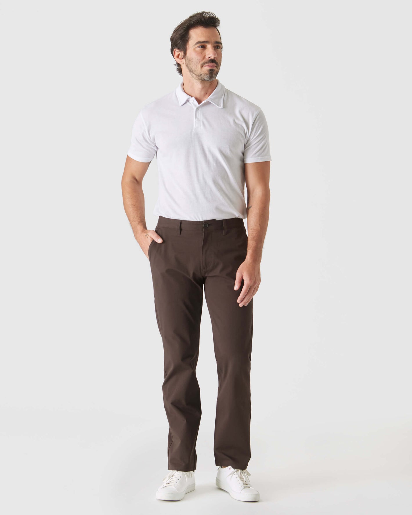 Man wearing Dark Oak Straight Twill Chino Pant with white polo.