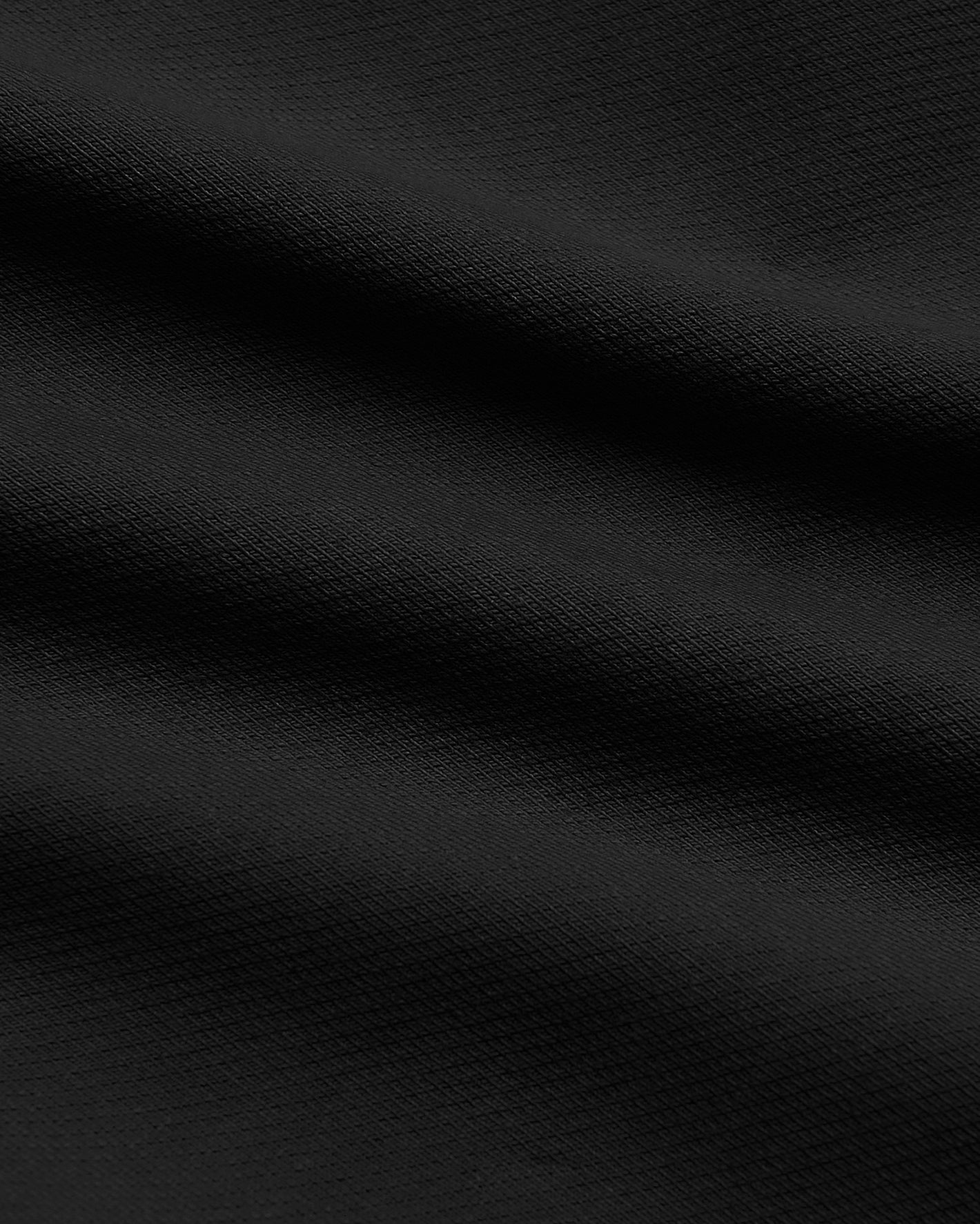 Black Slim Chino Pants 2.0 with textured woven fabric folds.