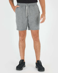 True ClassicNeutral Active Comfort Shorts 3-Pack in heather-gray, mid-thigh length, with black running shoes.