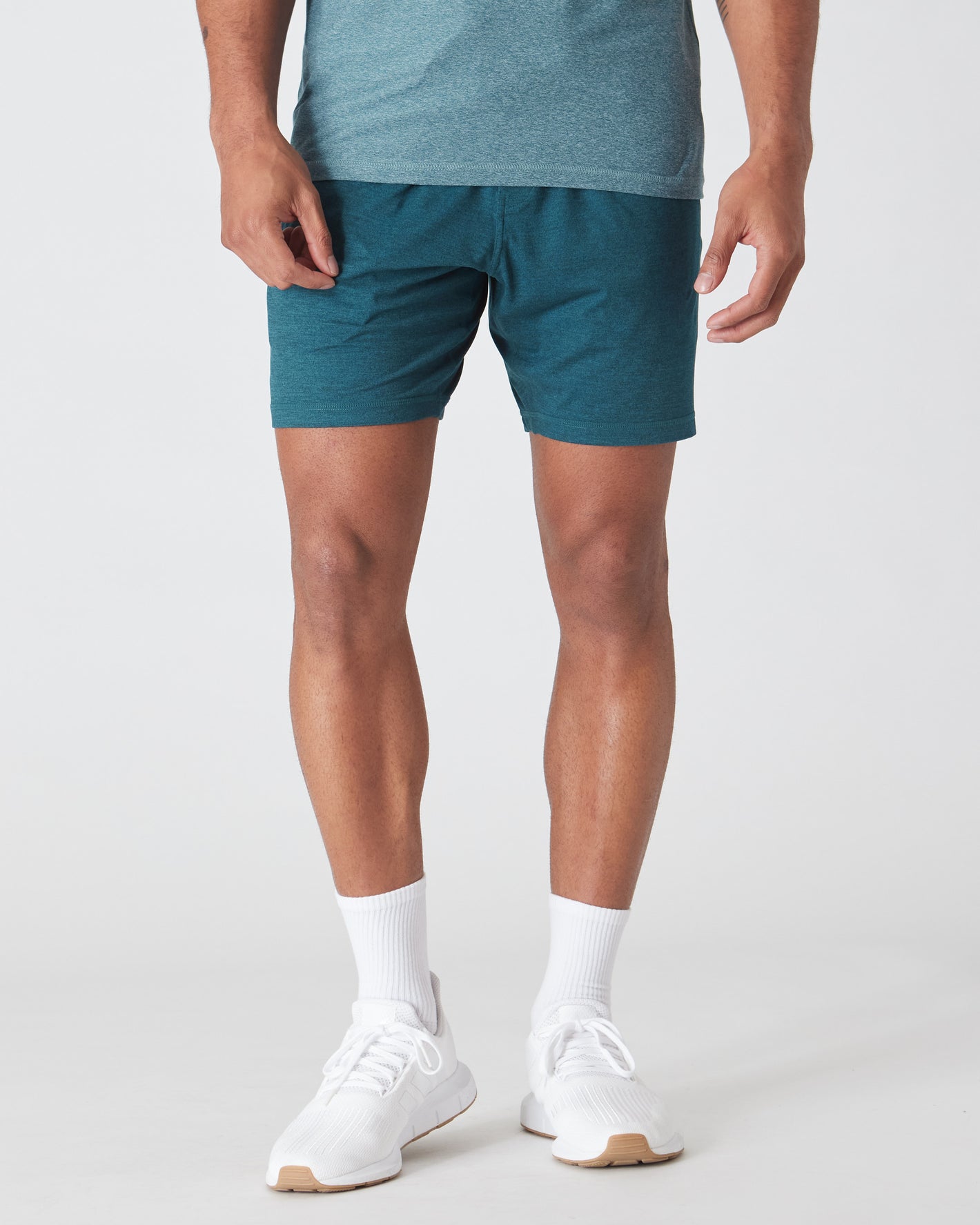 Model wearing Dark Heather Centurion Active Comfort Shorts with white sneakers.