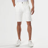 Ivory Neutral Chino Shorts with side pockets, belt loops, paired with sneakers.