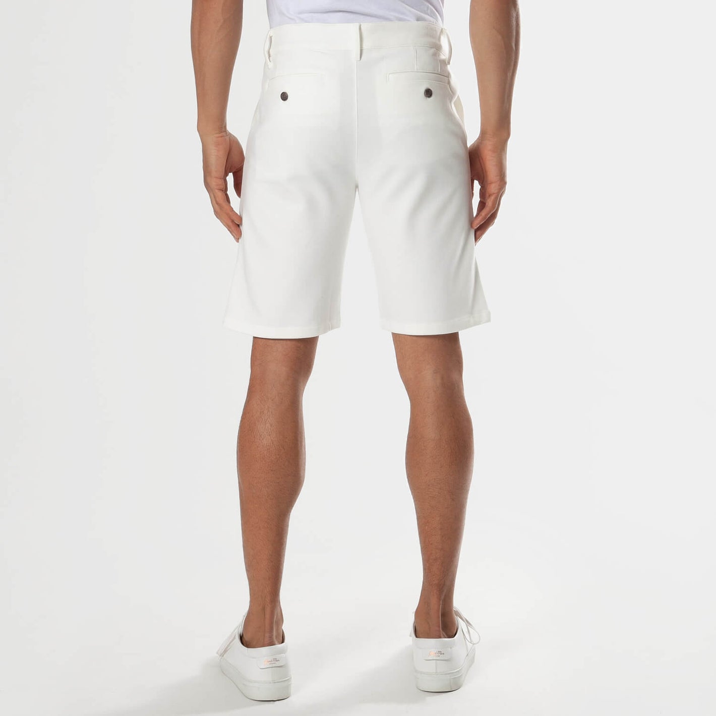 Ivory Neutral Chino Shorts, back view, knee-length, with sneakers.