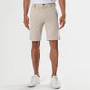 Sandstone Neutral Chino Shorts, knee-length with white sneakers.