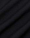 Black Commuter Short fabric close-up, highlighting fine woven texture and soft folds.