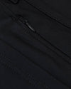 Black Commuter Short fabric close-up with stitching and zipper pull.