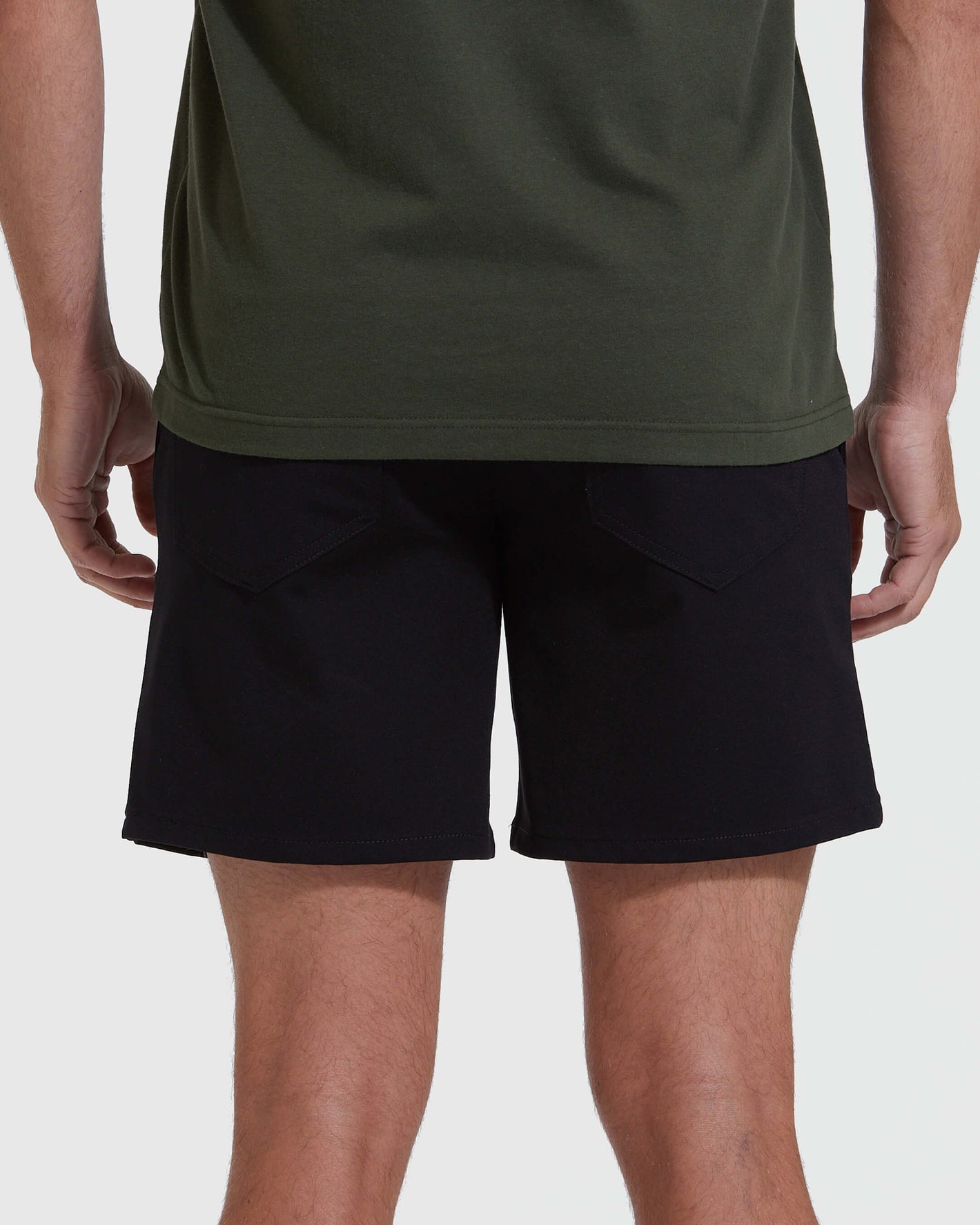 Back view of Black Commuter Short on model, highlighting slim fit.