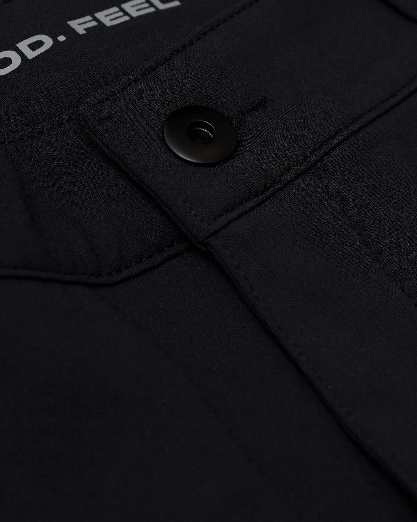 Black Commuter Short close-up showing flap pocket with snap button.