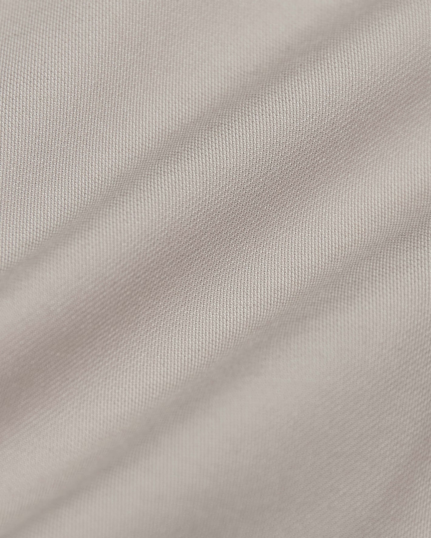 Sandstone Commuter Short fabric showcasing fine diagonal weave and gentle draping.