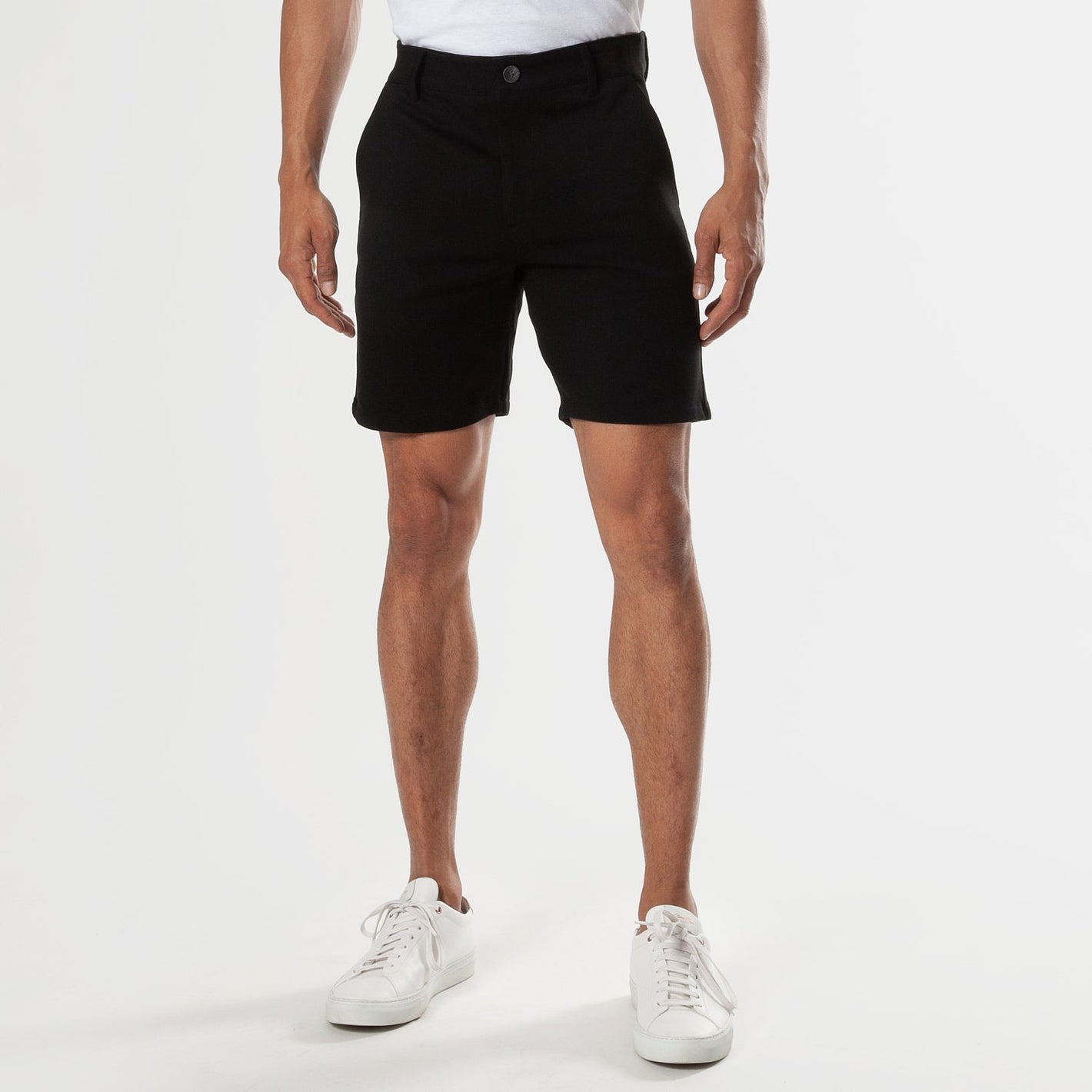 7 Black Comfort Knit Chino Shorts, button-front, worn with white sneakers.