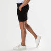 7 Black Comfort Knit Chino Shorts worn mid-step with white sneakers.