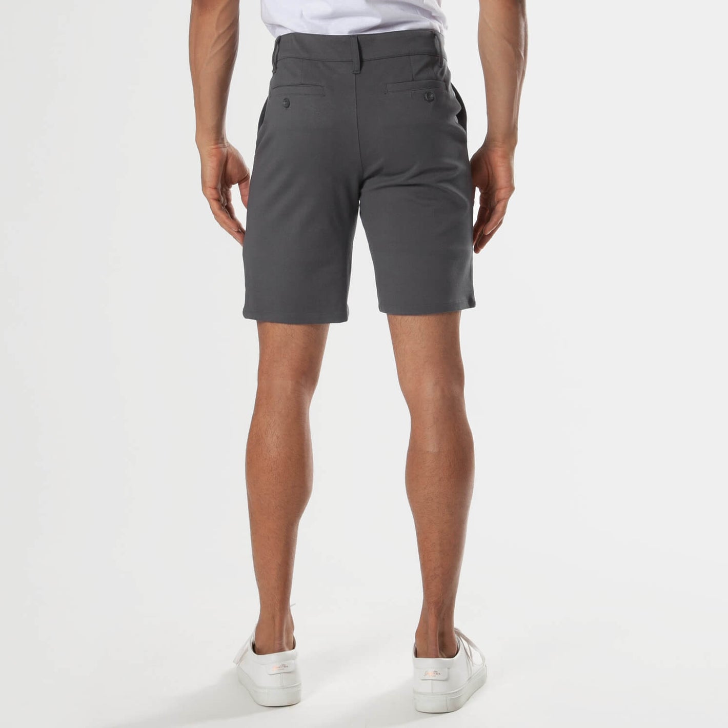 Back view of Carbon 7.5 Inseam Chino Shorts with sneakers.