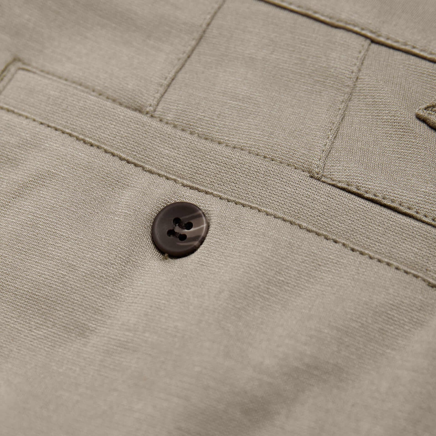 7 Khaki Comfort Knit Chino Shorts with welt pocket and brown button.