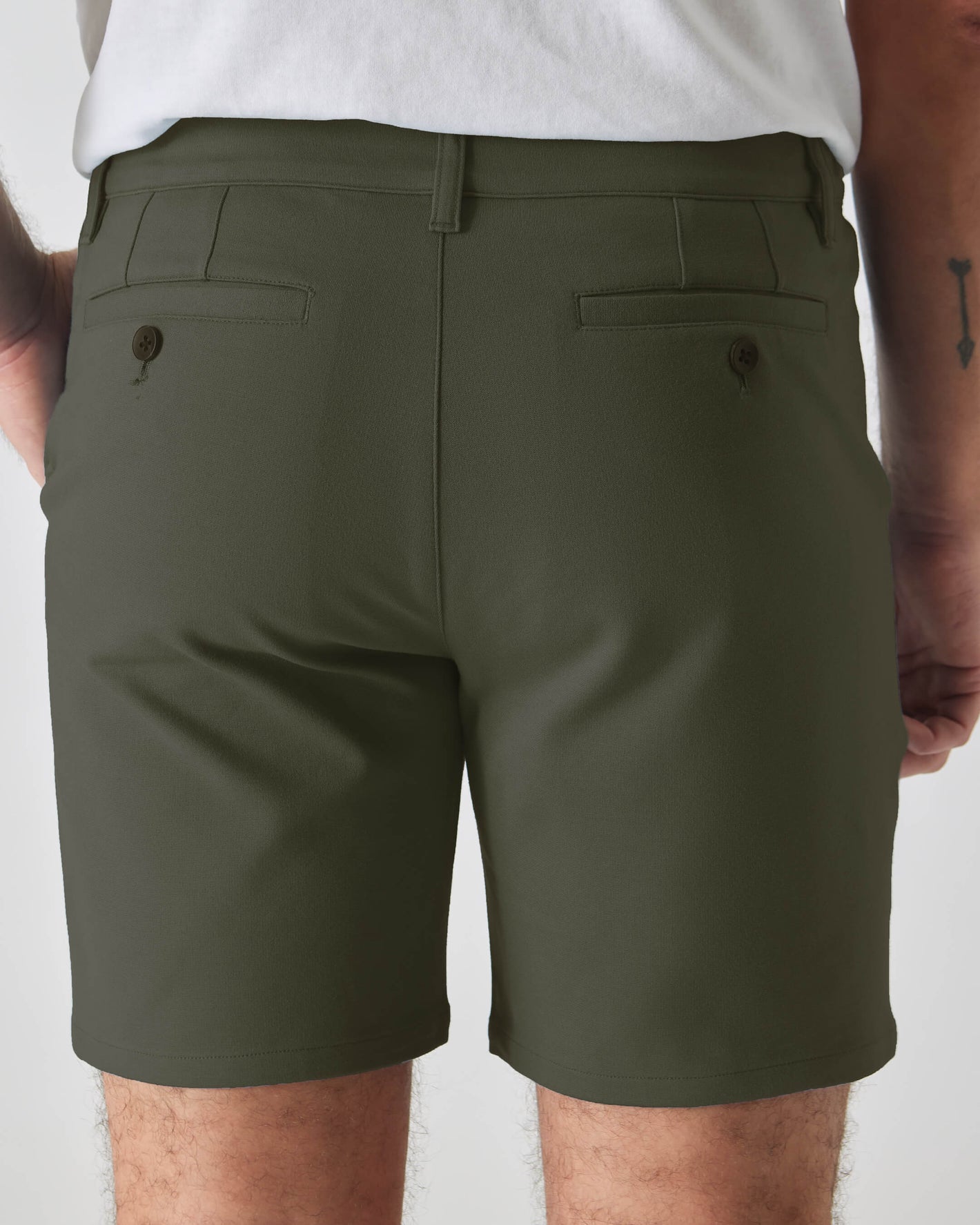 Man in 7 Military Green Comfort Knit Chino Short, rear view.