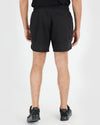 7 Black Active Training Shorts 2.0 with zippered pocket, worn by standing individual.
