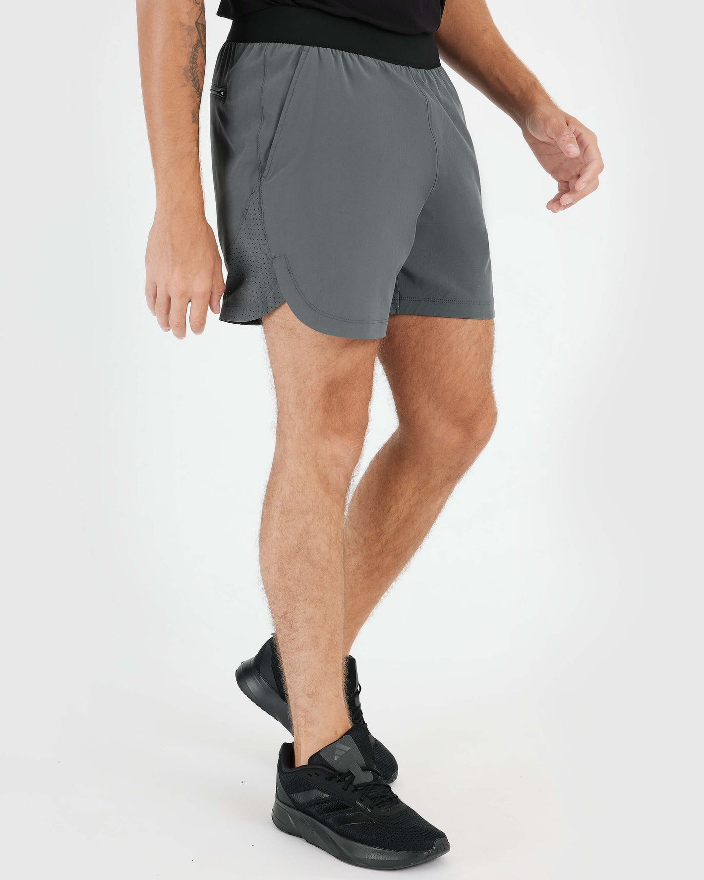 7 Carbon Active Training Short with black waistband, black shoes, white background.