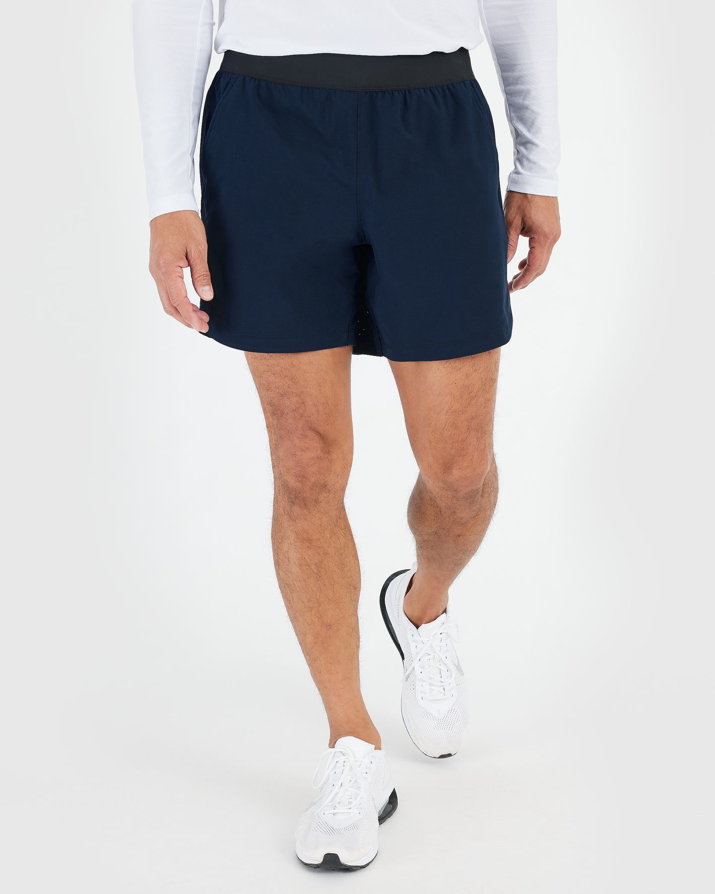 7 Navy Active Training Shorts 2.0 in a walking pose.
