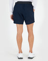7 Navy Active Training Shorts 2.0, back view, with sneakers.