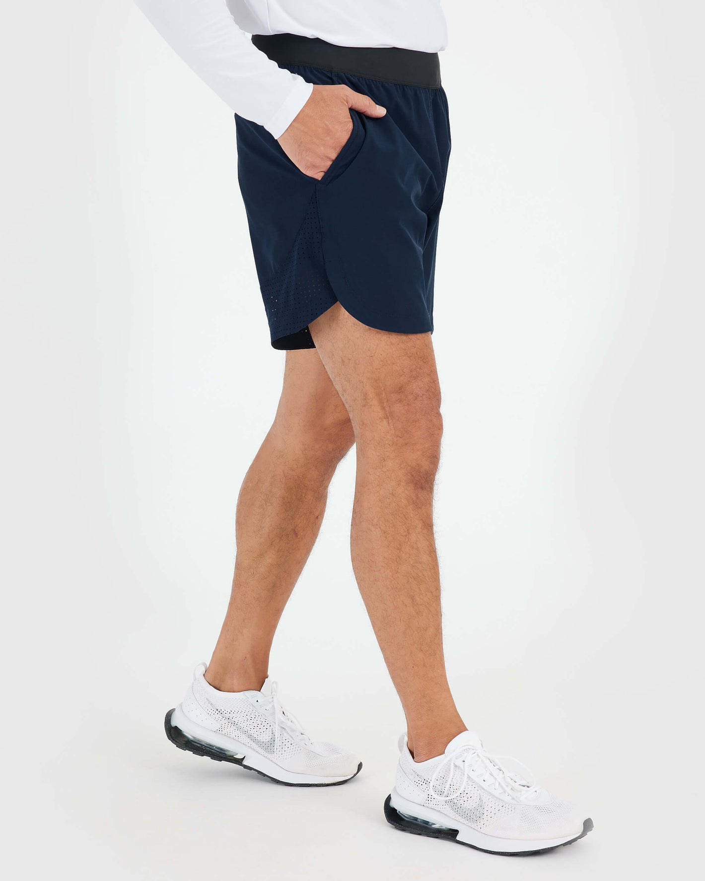 7 Navy Active Training Short with scallop hem and zippered pockets.