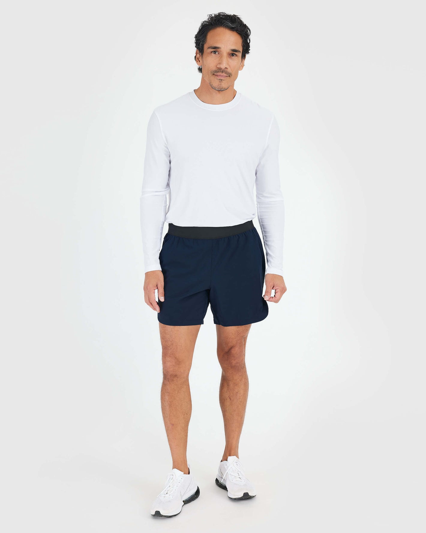 Man wears 7 Navy Active Training Short, showcasing athletic features.