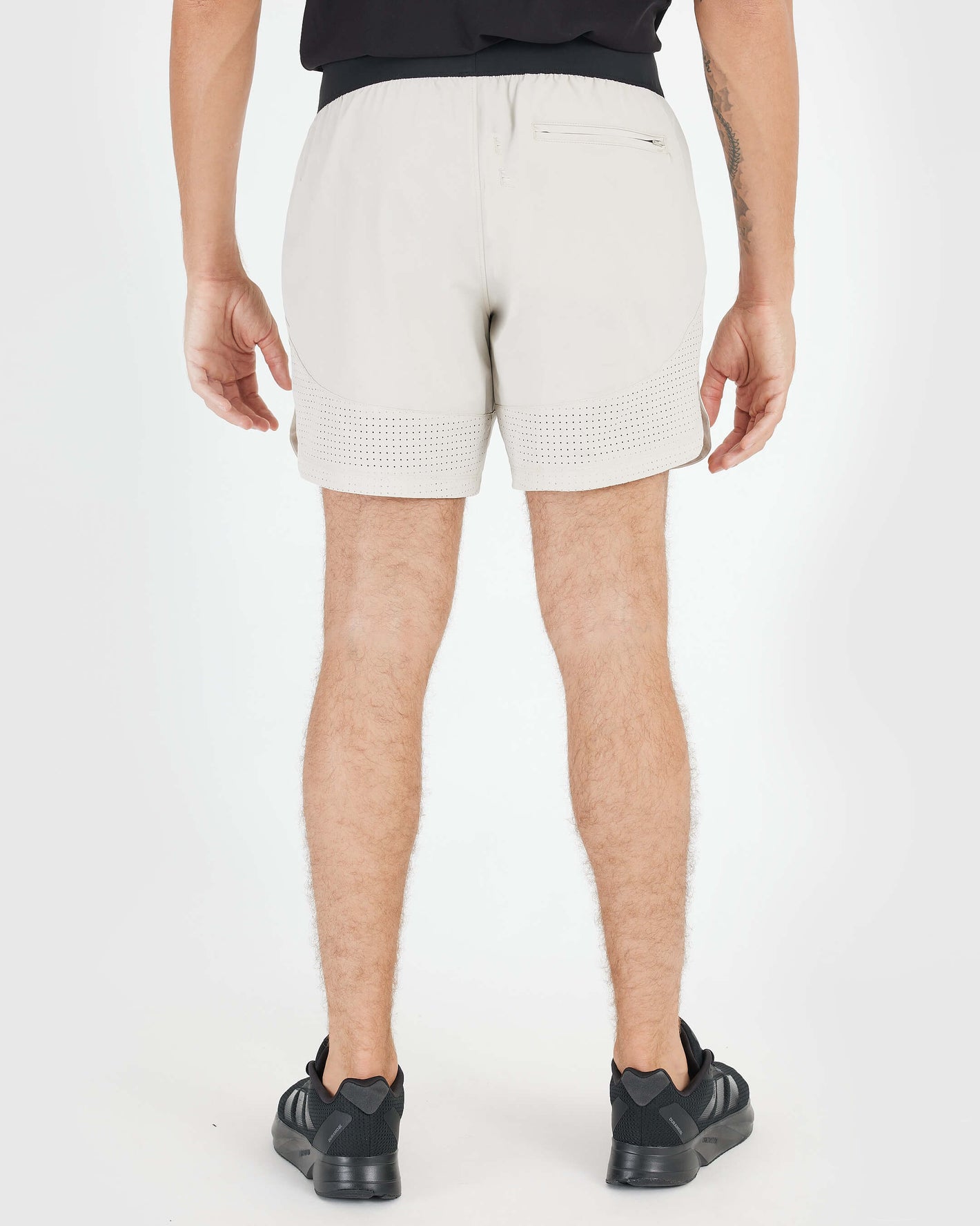 7 Sandstone Active Training Short, mid-thigh length, perforated hems, zip pocket.