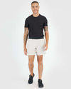 Young man wearing 7 Sandstone Active Training Short, stepping forward and smiling.