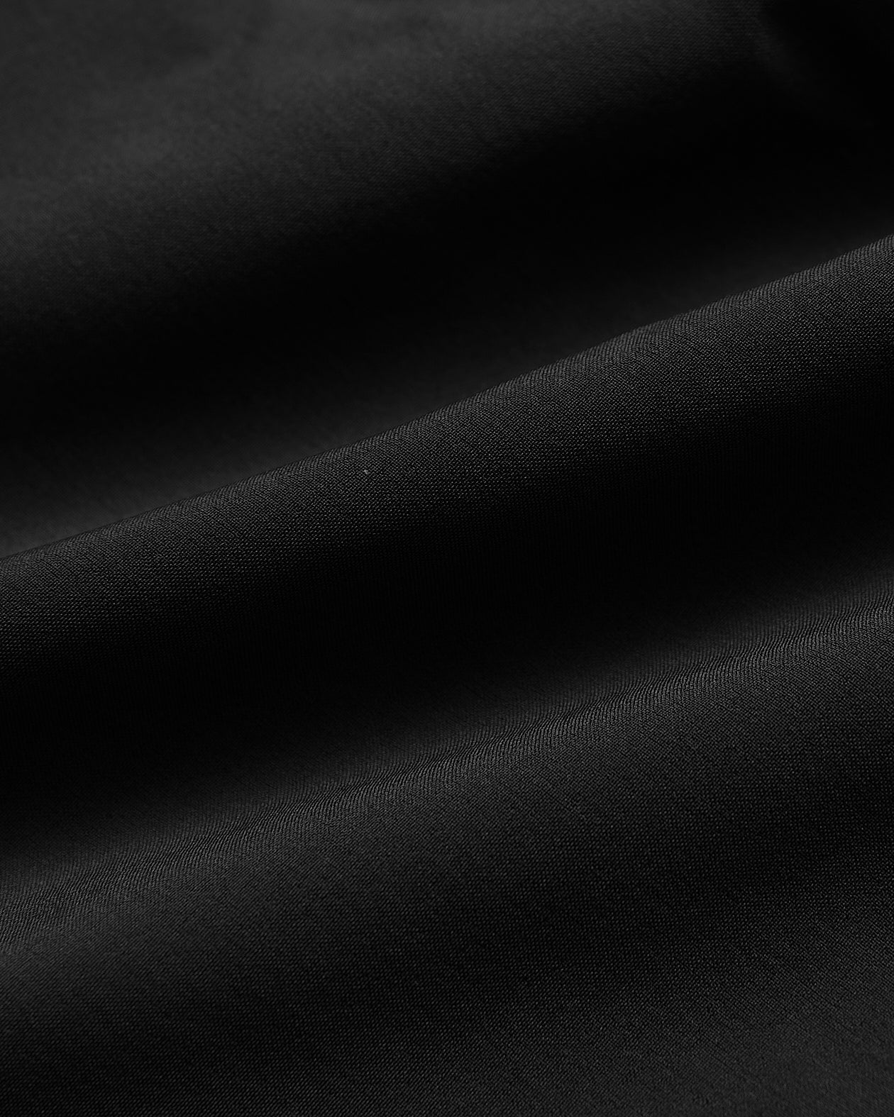 7 Black Active Training Shorts 2.0 fabric close-up, showcasing weave and drape.