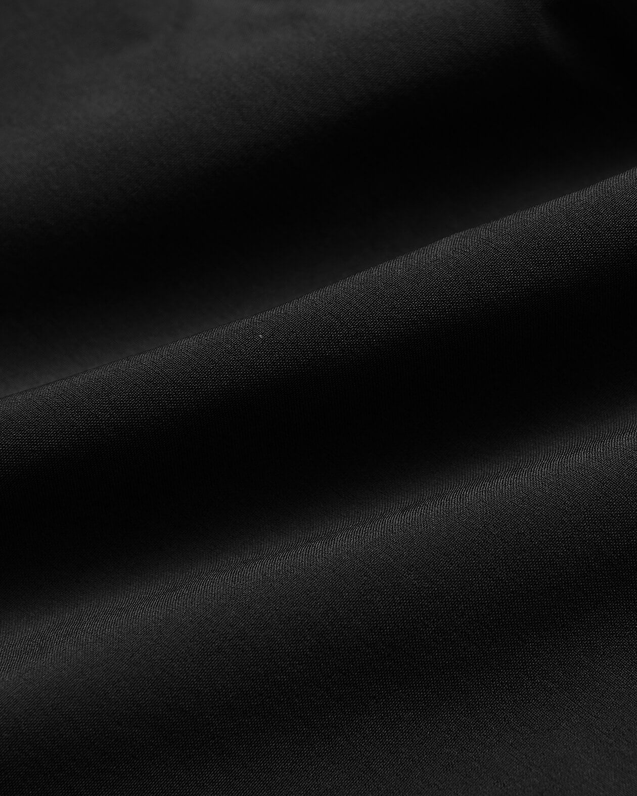 7 Black Active Training Short with smooth fabric and gentle folds.