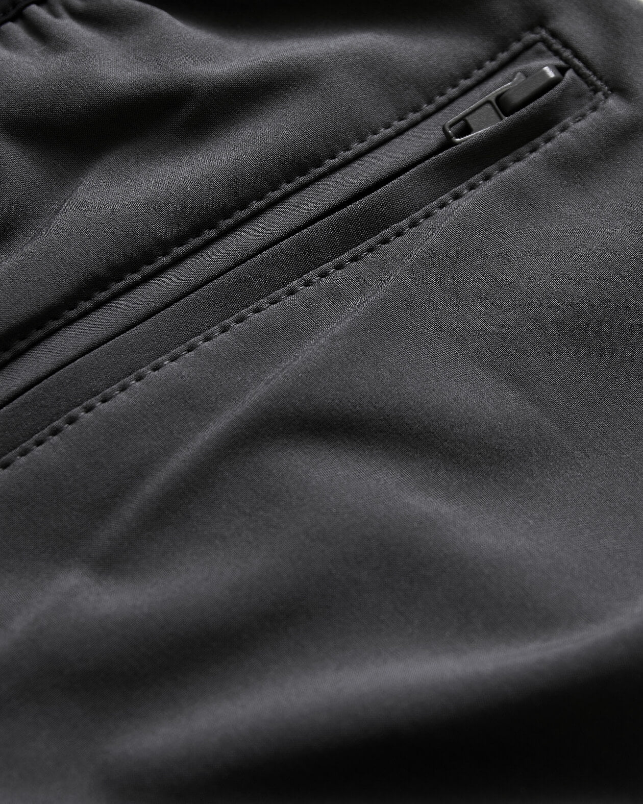 7 Carbon Active Training Short close-up, showcasing smooth fabric and zippered pocket.