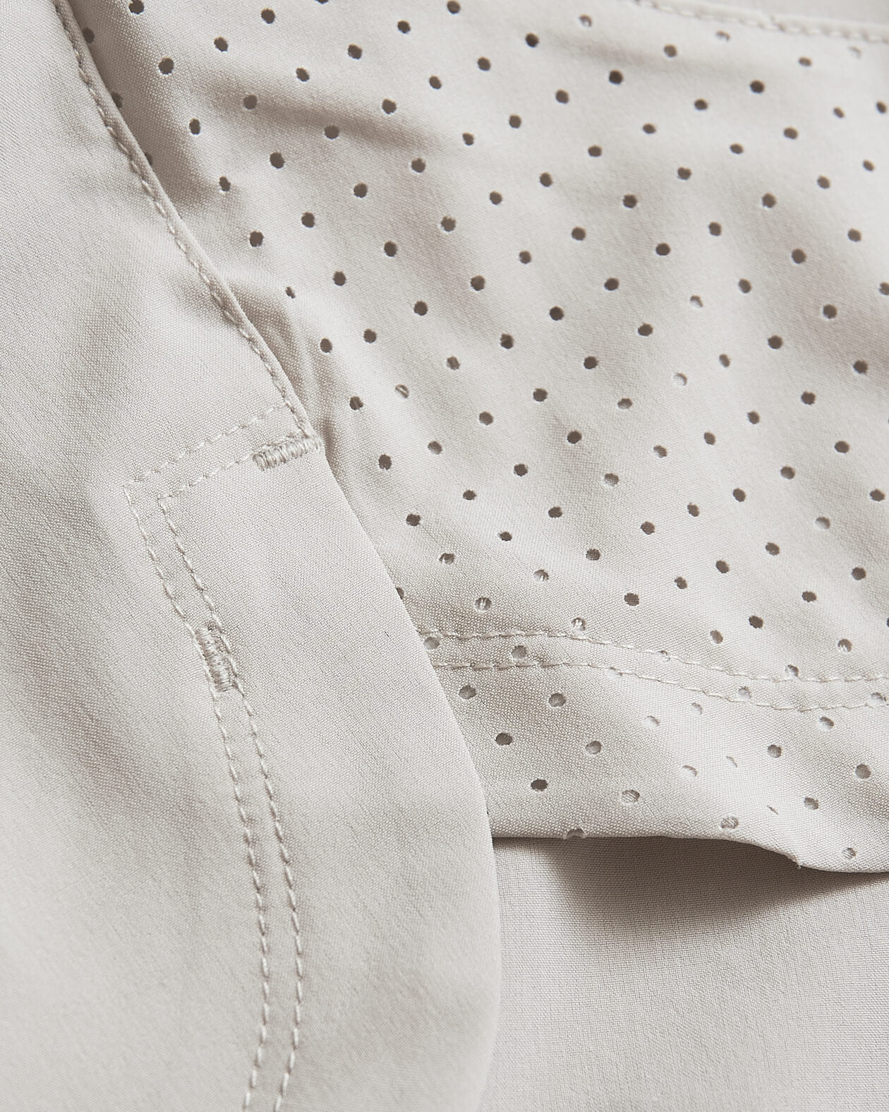 7 Sandstone Active Training Short fabric detail with perforated breathable panel.