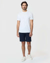 Man wearing Navy Twill Short with white t-shirt and sneakers.