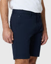 Man wearing Navy Twill Short with tattooed legs visible.