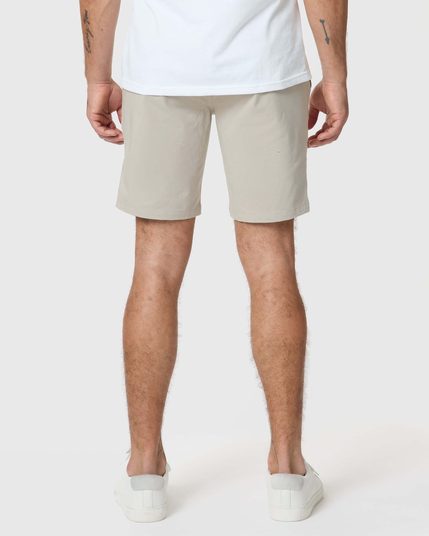 Back view of Sandstone Twill Short worn with white sneakers.